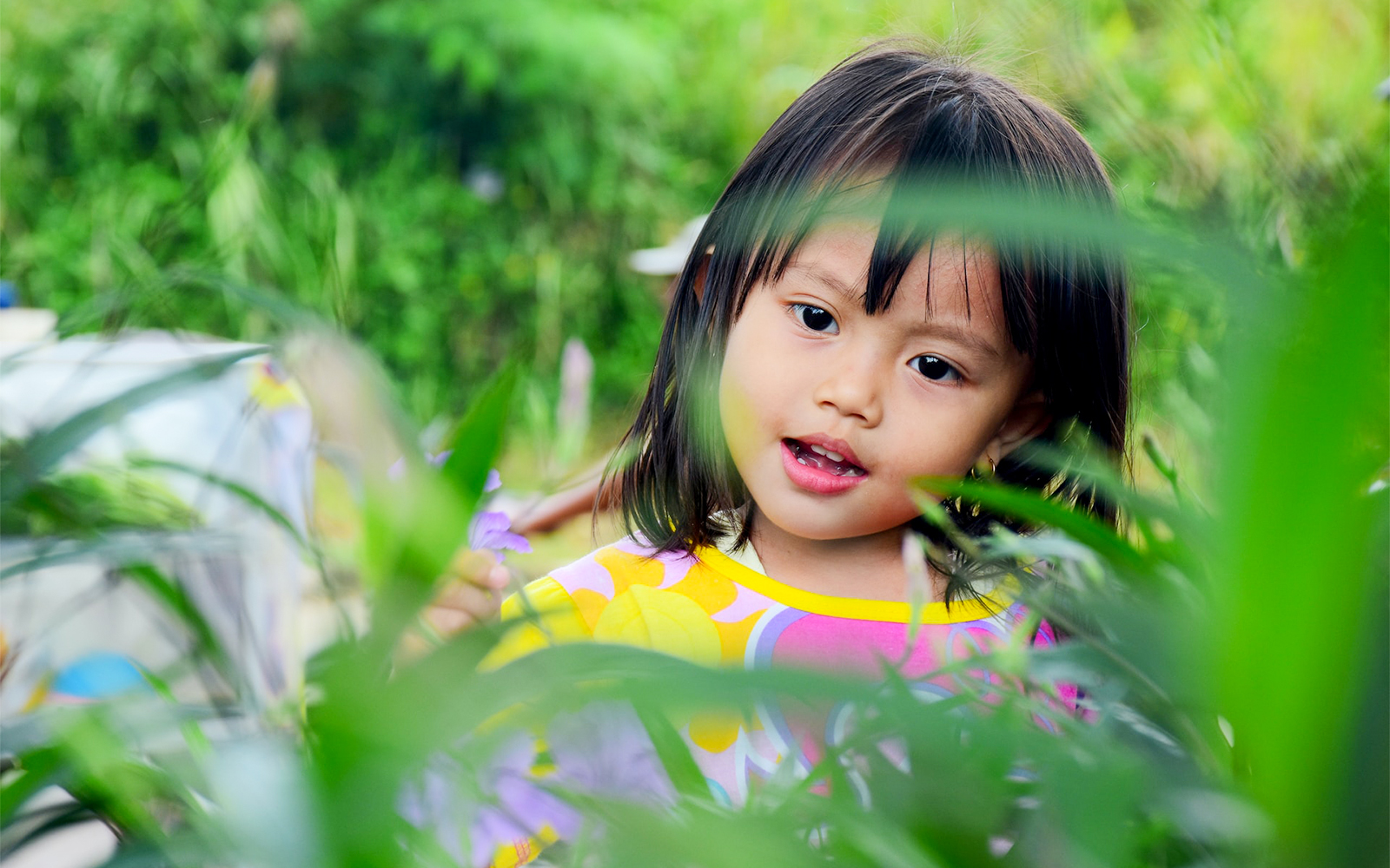 Children exploring vibrant flowers at Kew Gardens, Royal Botanic Gardens, London.