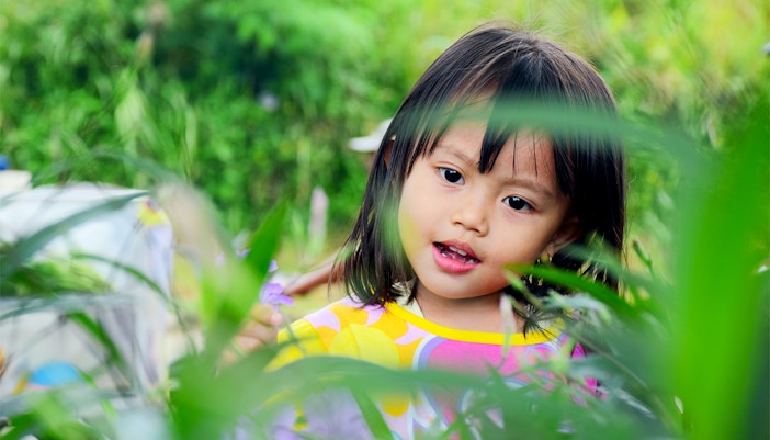 Children exploring vibrant flowers at Kew Gardens, Royal Botanic Gardens, London.