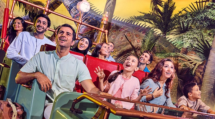 Visitors enjoying a dinosaur-themed ride at IMG Worlds of Adventure, Dubai.