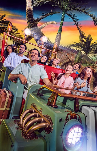 Visitors enjoying a dinosaur-themed ride at IMG Worlds of Adventure, Dubai.