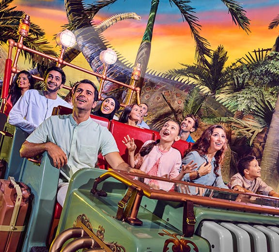 Visitors enjoying a dinosaur-themed ride at IMG Worlds of Adventure, Dubai.
