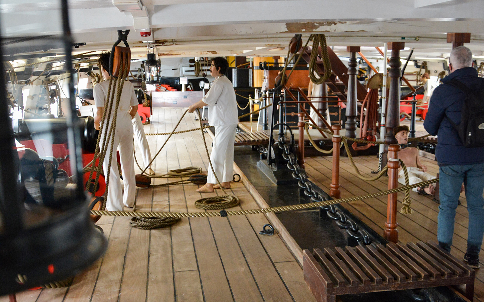 Crew members handling ropes on the deck of Frigate D. Fernando II e Glória.
