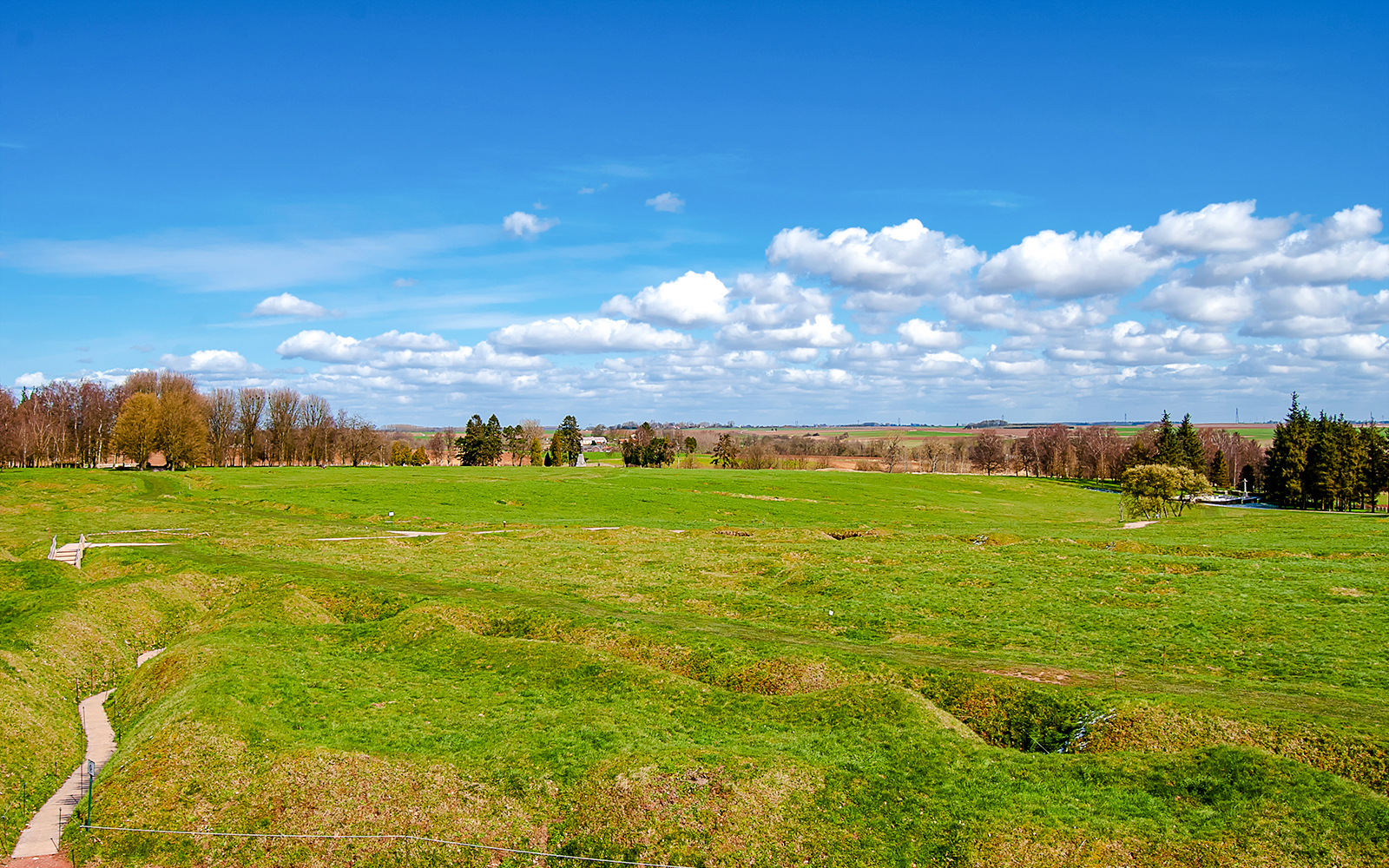 Beaumont Hamel battlefield with preserved trenches and grassy landscape.