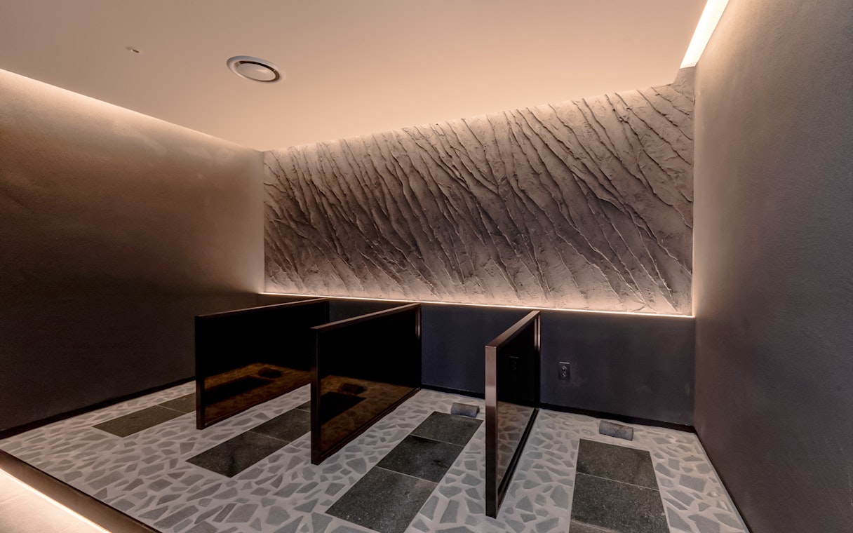 Private shower stalls in the spa at Club D Oasis with textured walls.