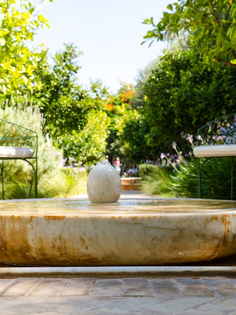Fountain in Jardin Secret surrounded by greenery, part of the Khettara water system.
