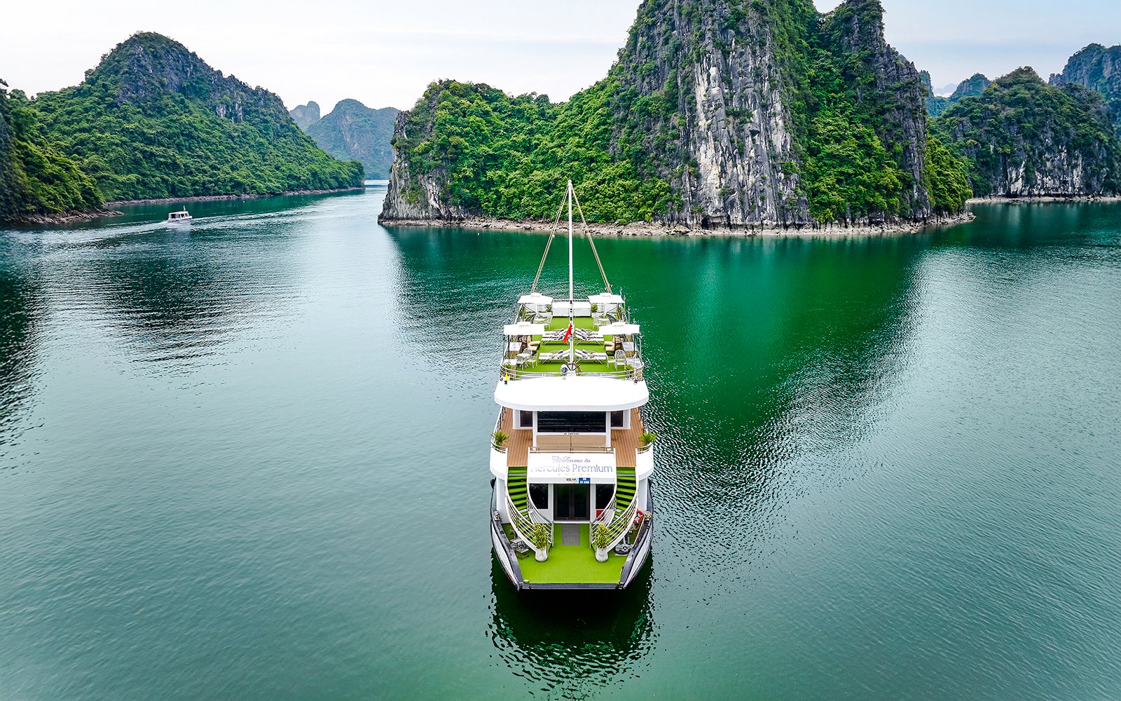 Cruise ship Hercules Premium sailing through limestone karsts in Halong Bay, Vietnam.