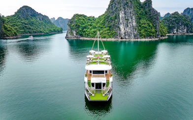 Cruise ship Hercules Premium sailing through limestone karsts in Halong Bay, Vietnam.