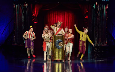 Performers in colorful costumes on stage during Kooza show in Brisbane.