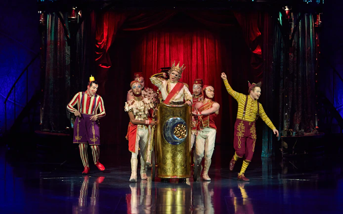 Performers in colorful costumes on stage during Kooza show in Brisbane.