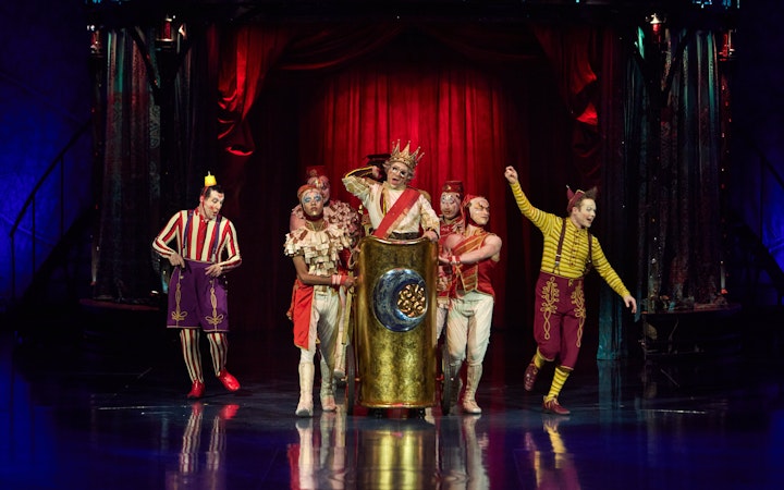 Performers in colorful costumes on stage during Kooza show in Brisbane.