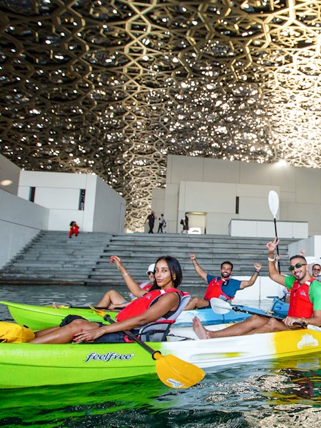 Tourists kayaking under the dome of Louvre Abu Dhabi.