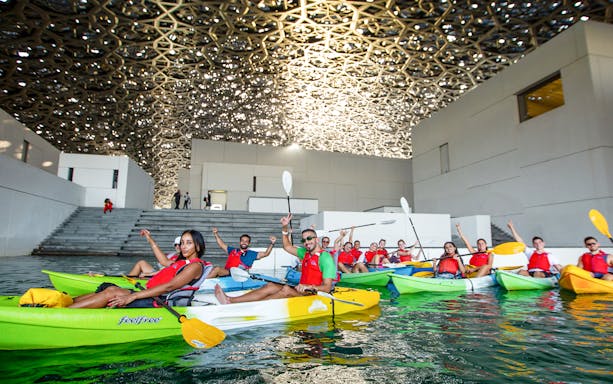 Tourists kayaking under the dome of Louvre Abu Dhabi.