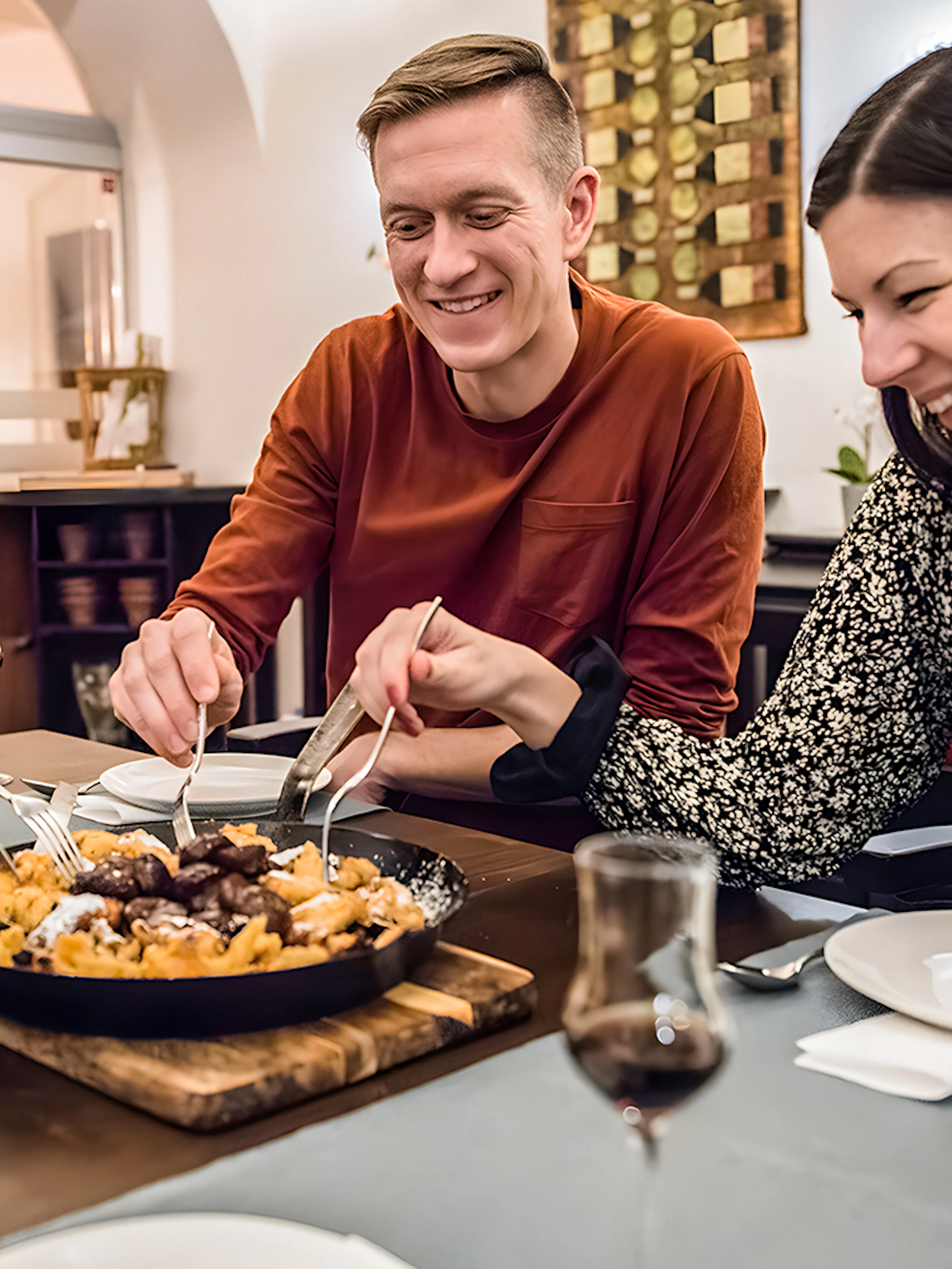 Participants enjoying Kaiserschmarrn at a dining table.