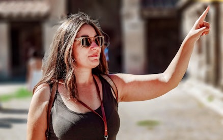 Tour guide pointing during Oplontis small group tour.