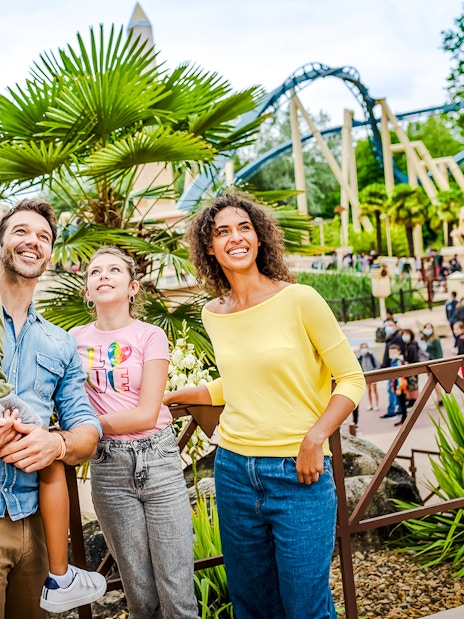 Family enjoying a day at Asterix Park with Egyptian-themed attractions in the background.