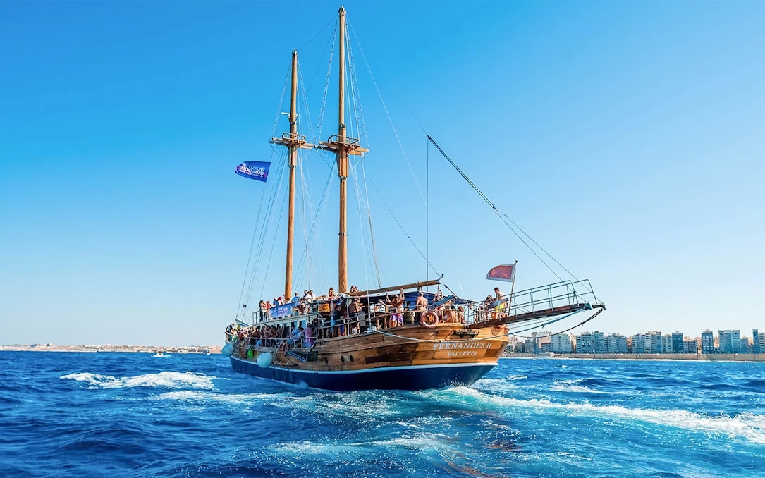 Turkish gulet sailing from Sliema to Gozo and Comino with passengers on deck.
