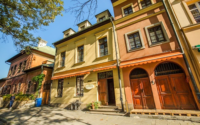 Historic buildings in the Jewish Quarter Kazimierz, Krakow, with colorful facades and arched doorways.