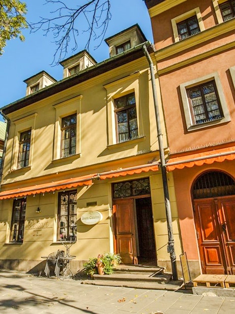 Historic buildings in the Jewish Quarter Kazimierz, Krakow, with colorful facades and arched doorways.