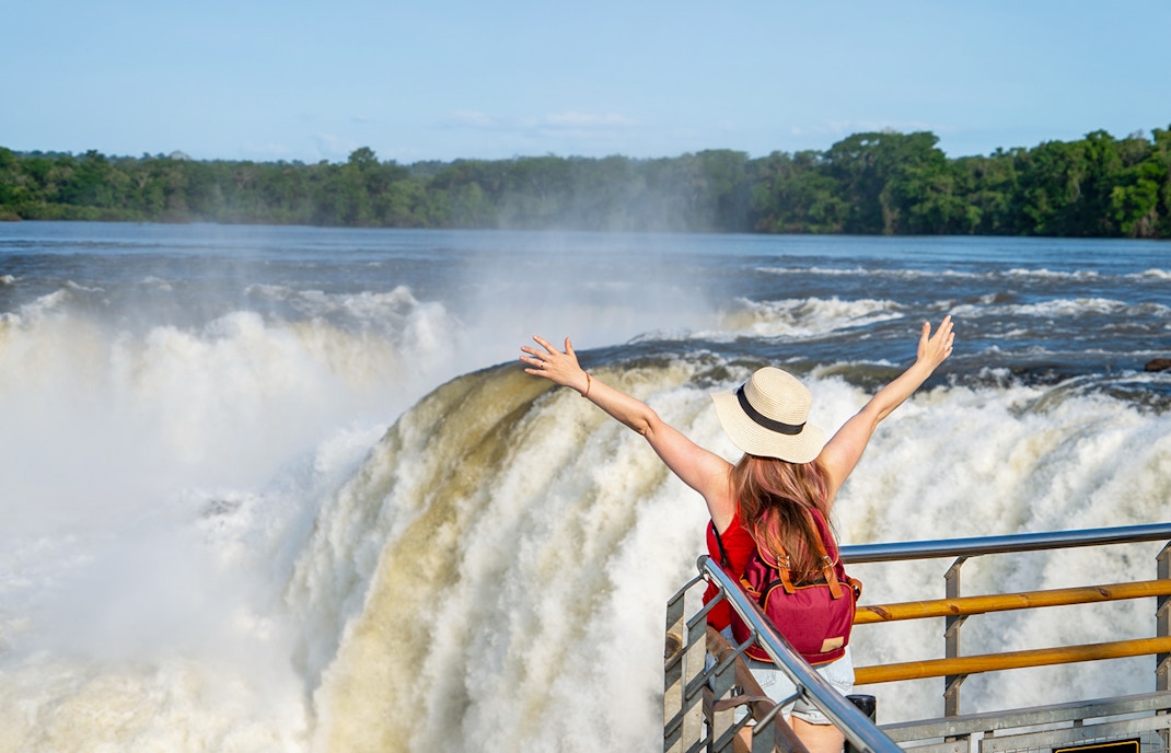 Female tourist admiring Iguazu Falls