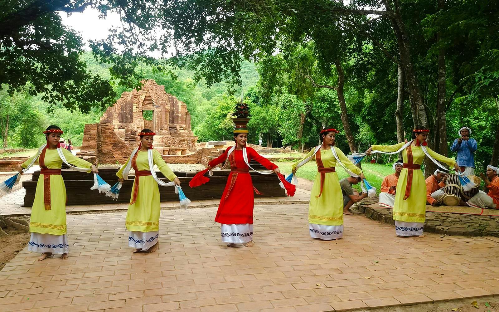 Traditional Cham dance at My Son Sanctuary, Vietnam, with ancient temple ruins in the background.