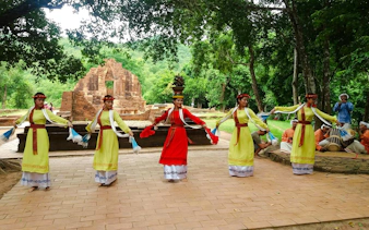 Traditional Cham dance at My Son Sanctuary, Vietnam, with ancient temple ruins in the background.