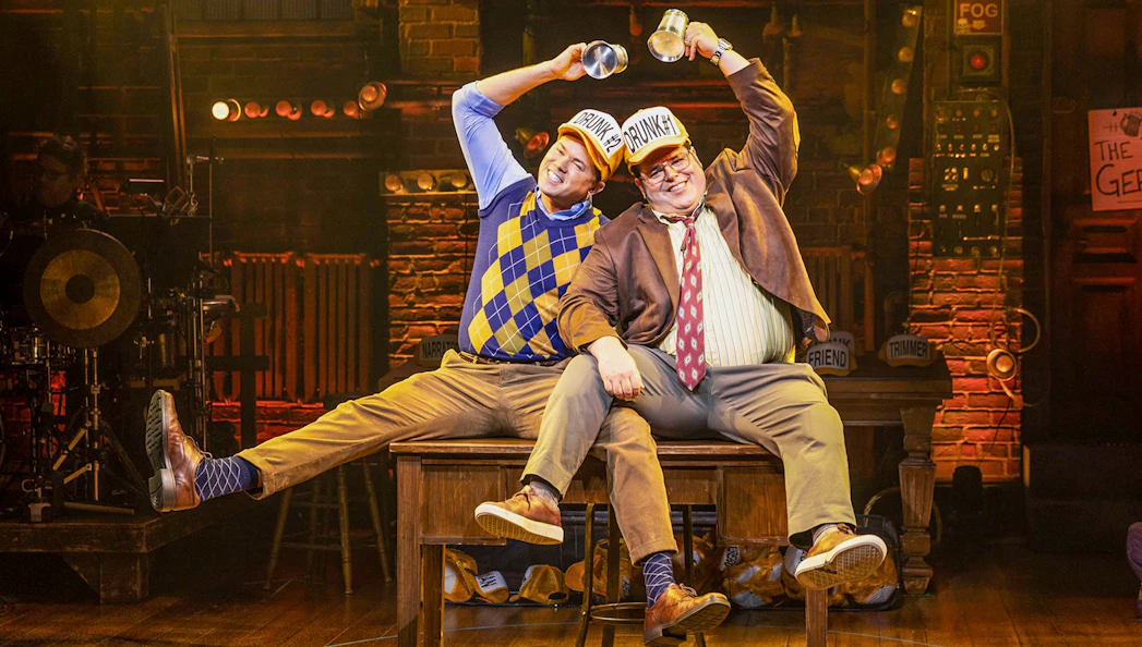 Two actors on stage performing a comedic scene in "Gutenberg! The Musical!