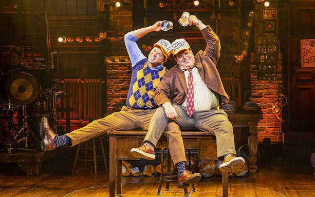 Two actors on stage performing a comedic scene in "Gutenberg! The Musical!