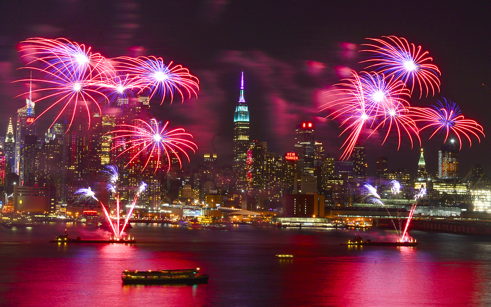Fireworks over New York City skyline during New Year’s Eve cruise.