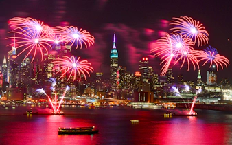 Fireworks over New York City skyline during New Year’s Eve cruise.