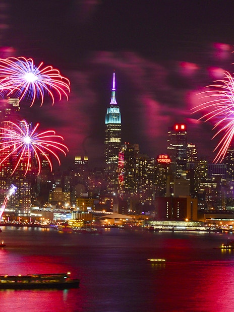 Fireworks over New York City skyline during New Year’s Eve cruise.