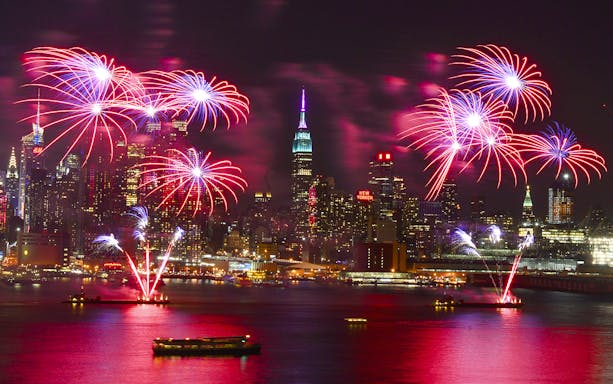 Fireworks over New York City skyline during New Year’s Eve cruise.