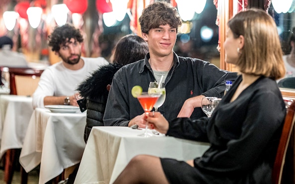 Guests enjoying drinks on a Danube sightseeing cruise.