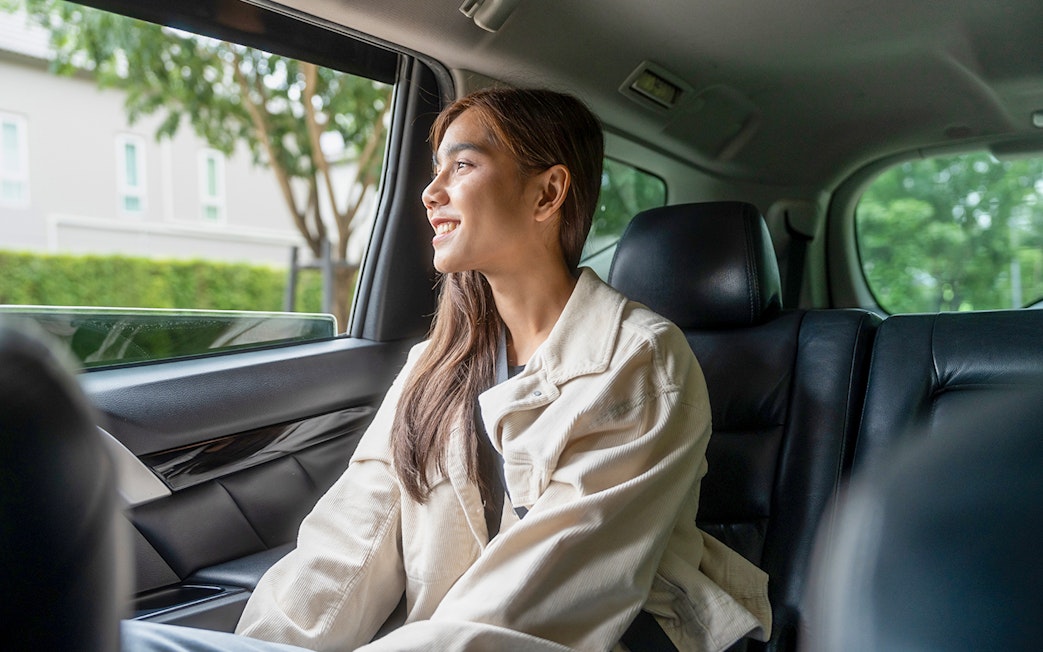Female guest enjoying car transfer from Tirana, looking out the window.