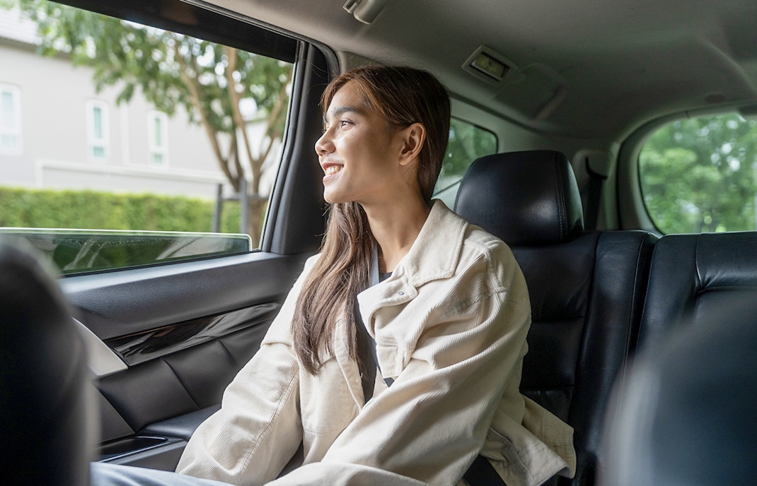 Female guest enjoying car transfer from Tirana, looking out the window.