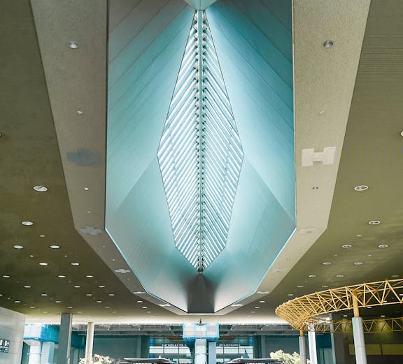 Kansai Airport terminal interior with modern architectural ceiling design.