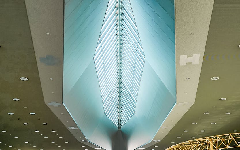 Kansai Airport terminal interior with modern architectural ceiling design.