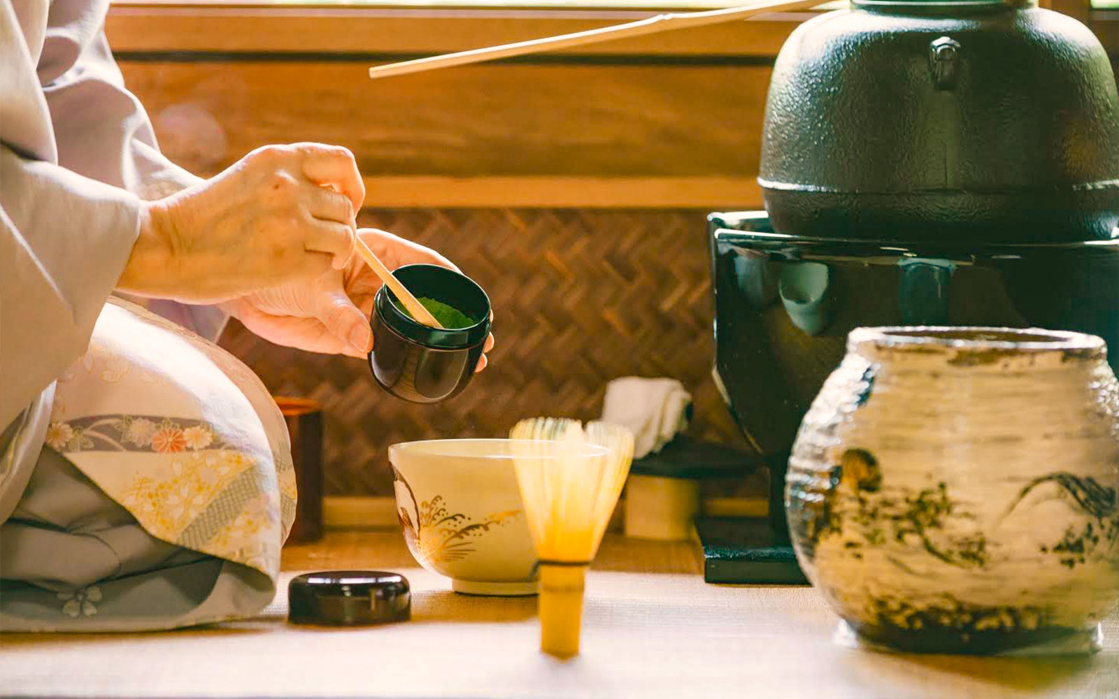 Tea ceremony preparation with matcha in a Kyoto teahouse.