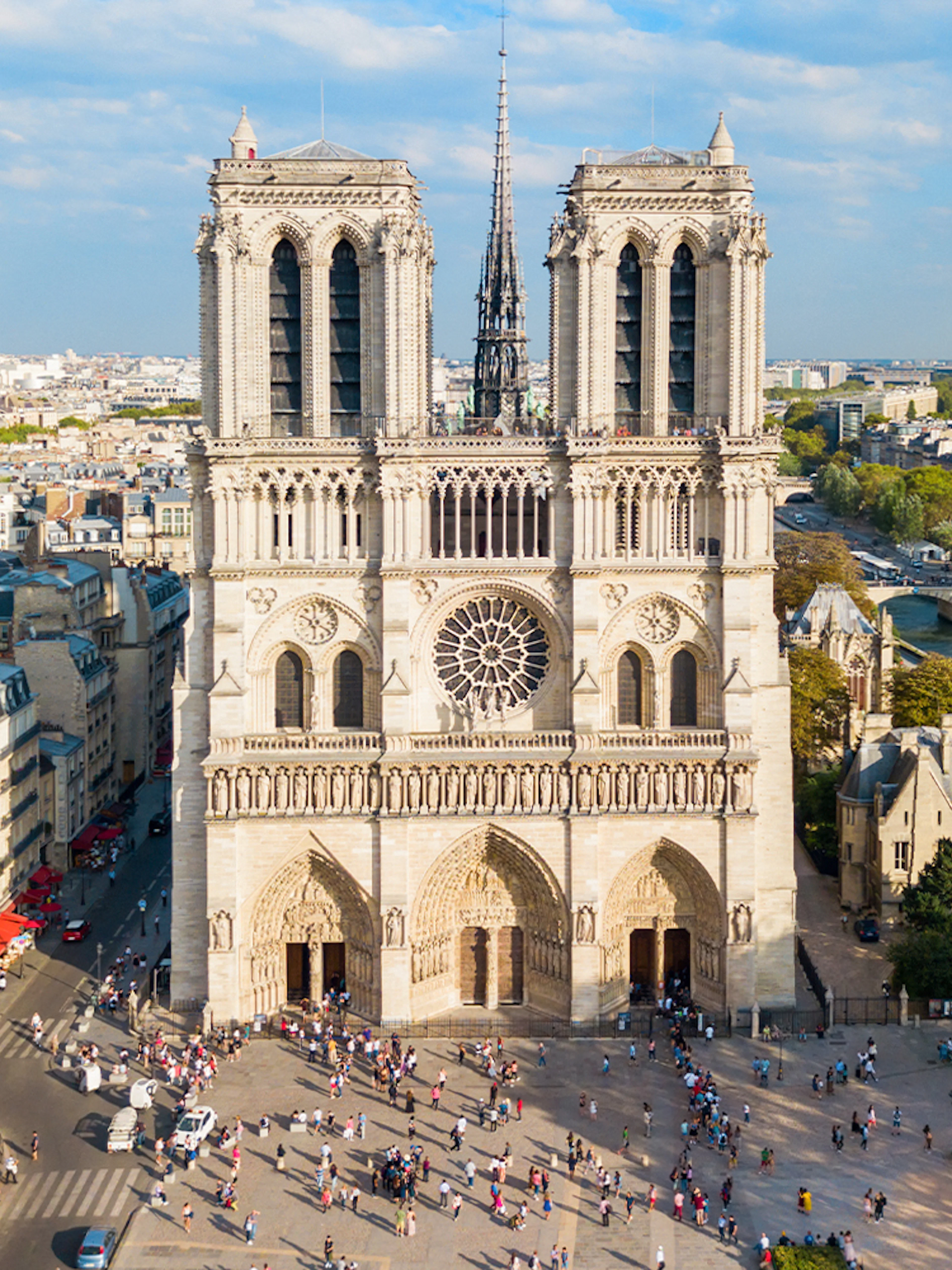 Notre Dame Cathedral in Paris with surrounding cityscape and Seine River.