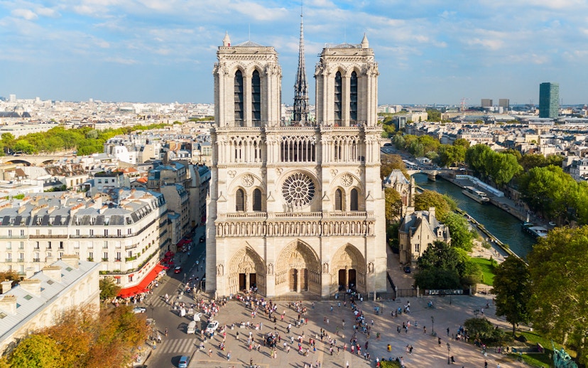 Notre Dame Cathedral in Paris with surrounding cityscape and Seine River.