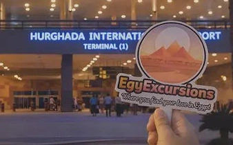 Hurghada International Airport entrance with EgyExcursions sign in foreground.