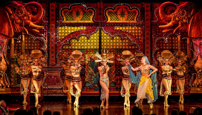 Performers in elaborate costumes on stage during the Pirates scene at Moulin Rouge show.