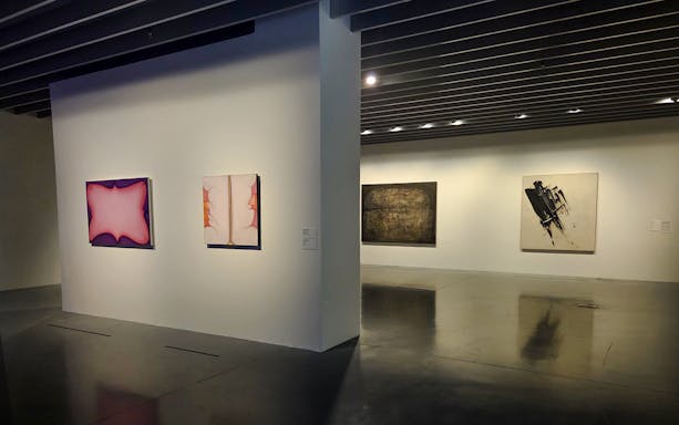 Centre Pompidou Malaga interior with visitors viewing modern art exhibition displays.