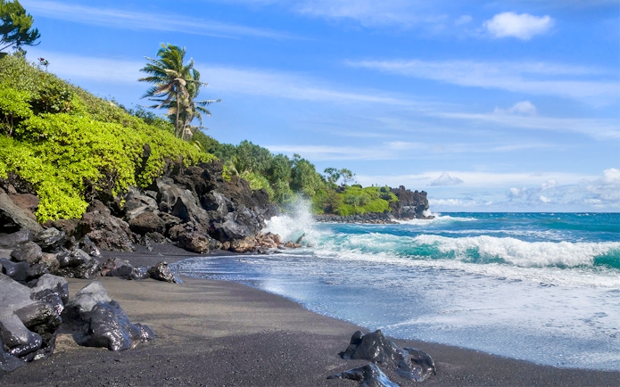 Waianapanapa State Park black sand beach with waves, part of Premium Road to Hana tour, Maui, Hawaii.