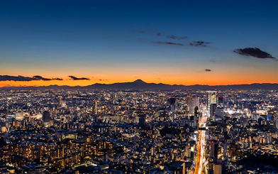 Tokyo skyline at sunset from Roppongi Hills Observation Deck, with Mount Fuji in the distance.