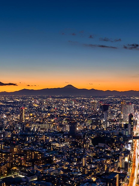 Tokyo skyline at sunset from Roppongi Hills Observation Deck, with Mount Fuji in the distance.