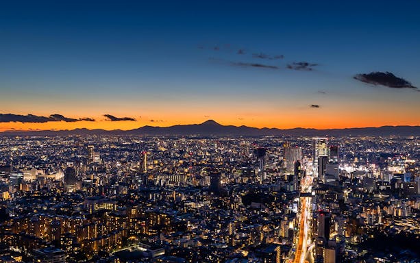 Tokyo skyline at sunset from Roppongi Hills Observation Deck, with Mount Fuji in the distance.