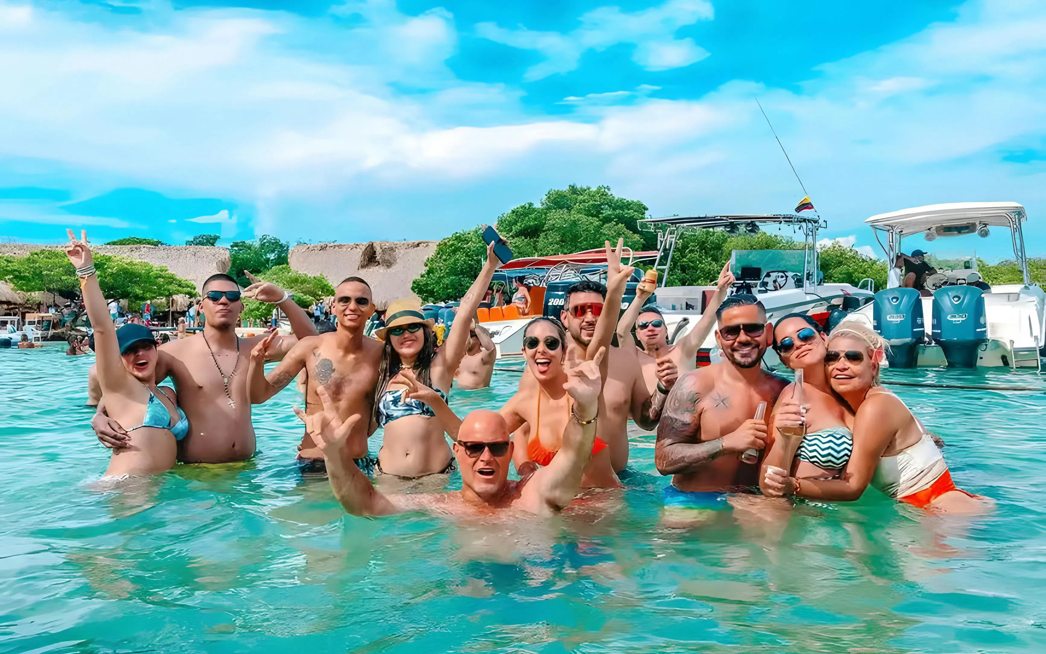 Tourists enjoying the water at Rosario Islands, Cartagena, Colombia with boats in the background.