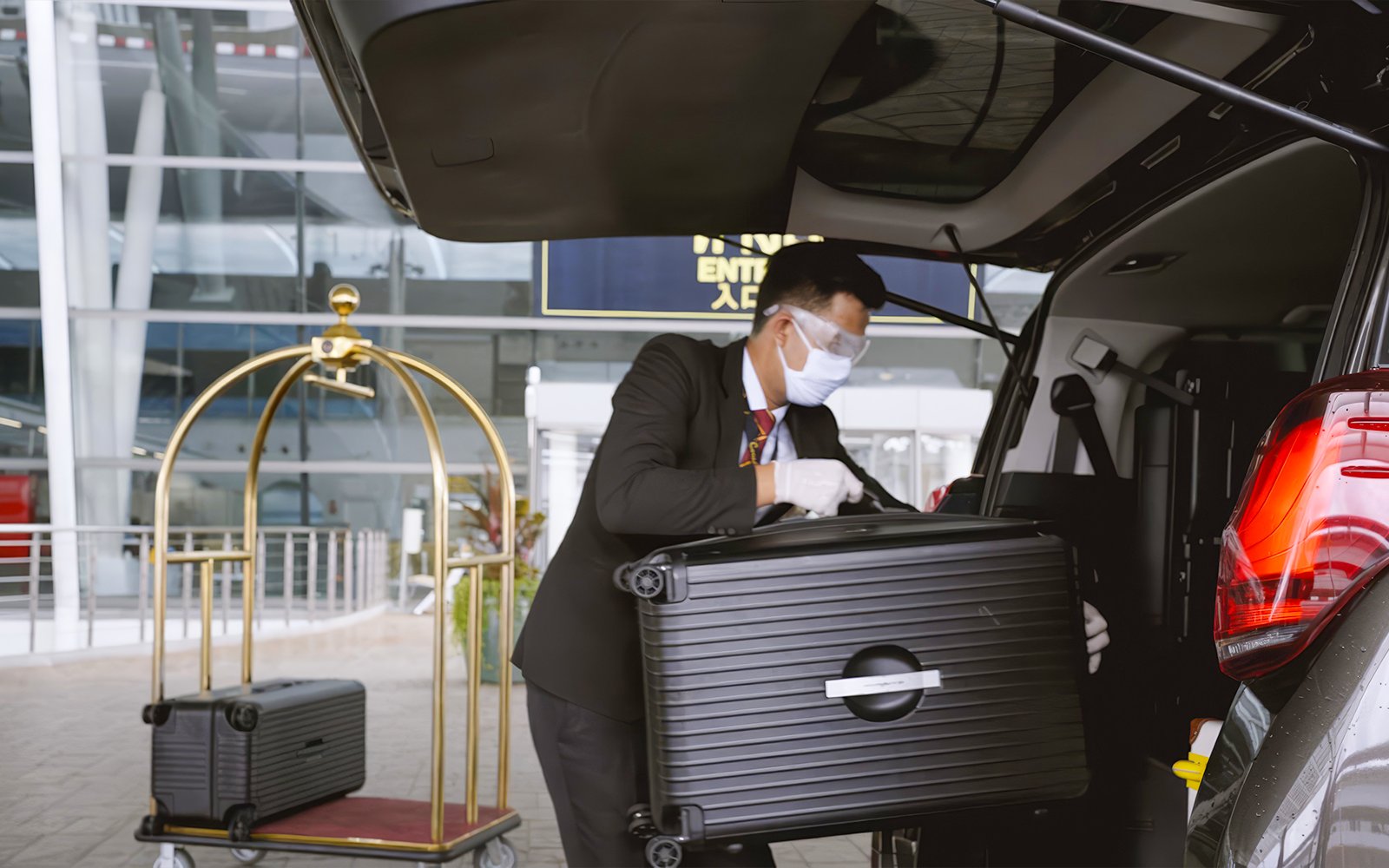 Loading luggage into car at Donmuang Airport VIP service area.