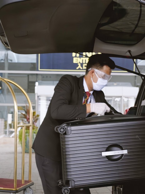 Loading luggage into car at Donmuang Airport VIP service area.