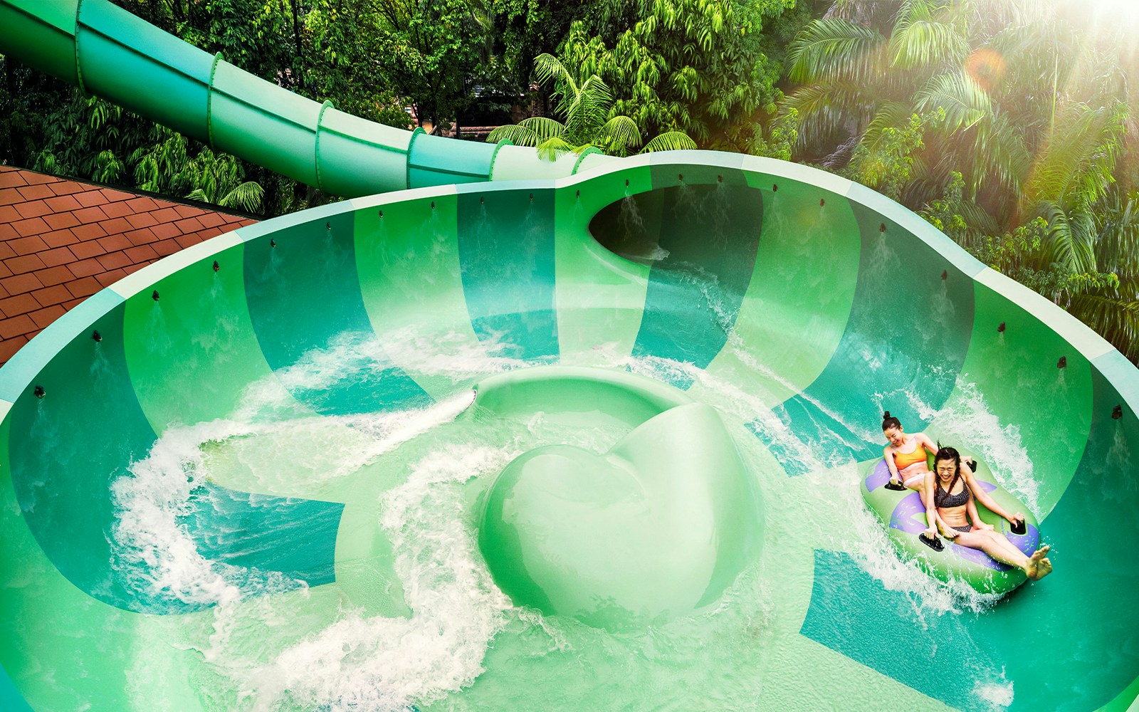 Guests on a water slide at Adventure Cove Waterpark